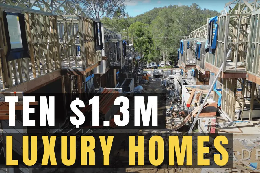 View of houses at Nature's Edge under construction looking down the driveway between the houses towards the entrance, with text overlay that says 'Ten 1.3 million dollar luxury homes'